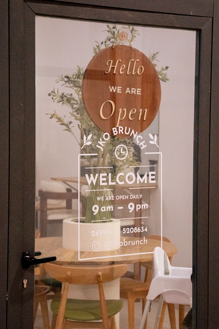 JKO Brunch entrance door with welcome signage and opening hours
